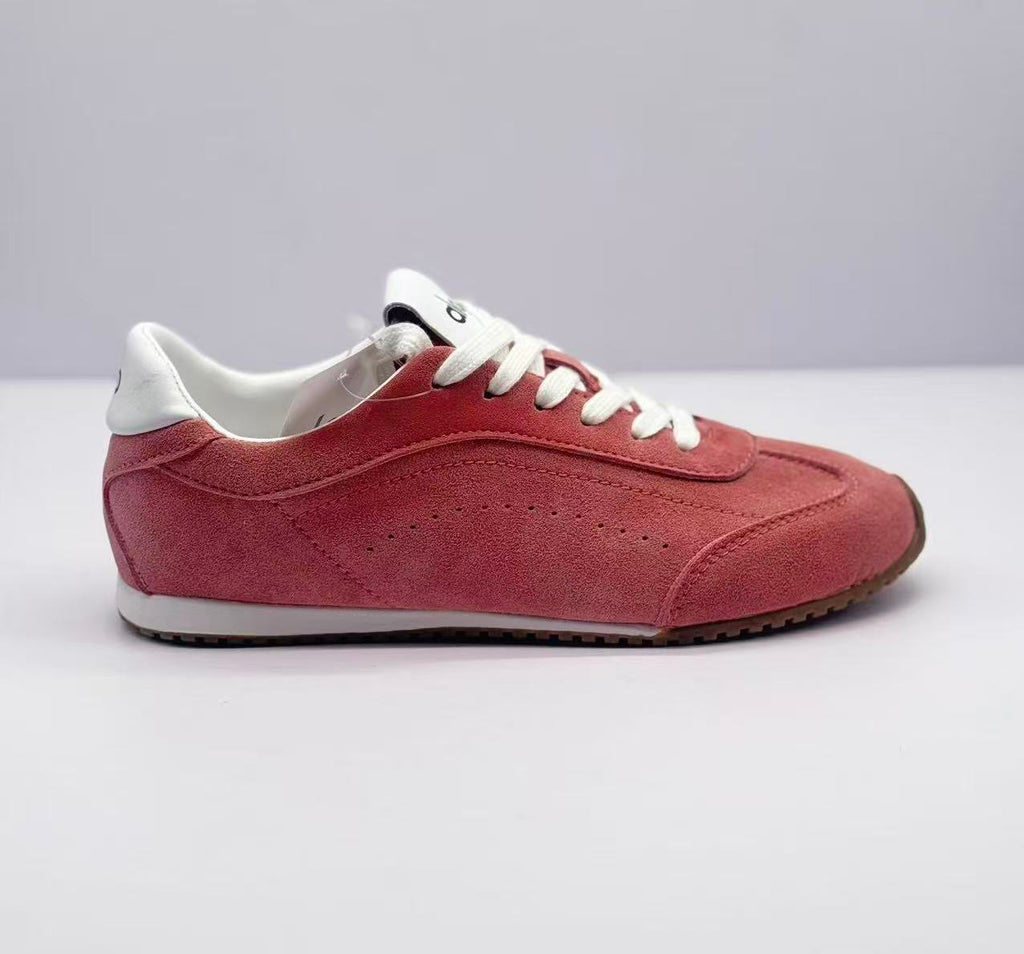 Lateral side view showing the pink textured upper, stitched panels and white midsole.