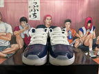 Front view of navy and white sneakers showing white laces and translucent-looking outsoles.