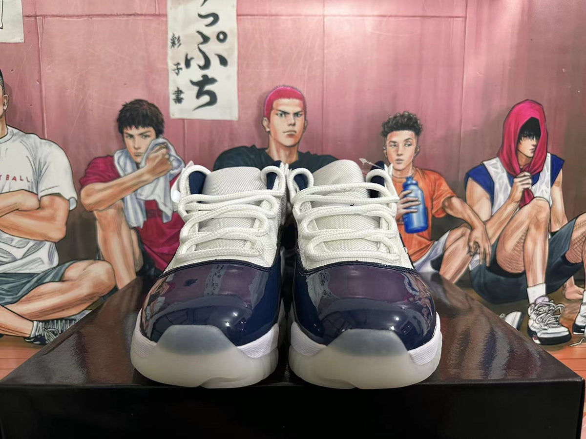 Front view of navy and white sneakers showing white laces and translucent-looking outsoles.