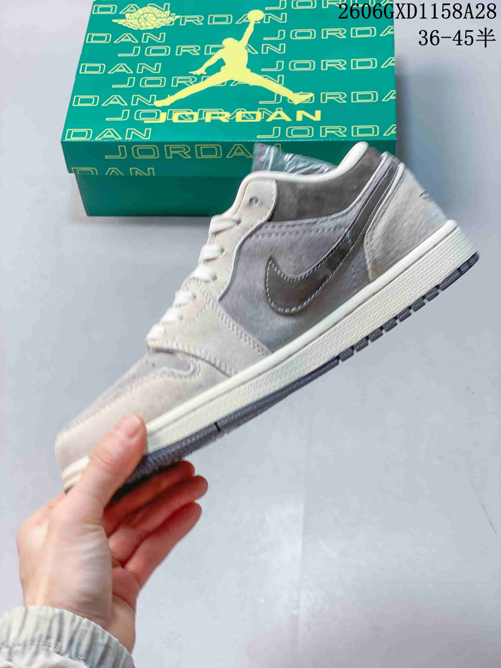 Side profile of the grey and brown low-top sneaker with a speckled Swoosh