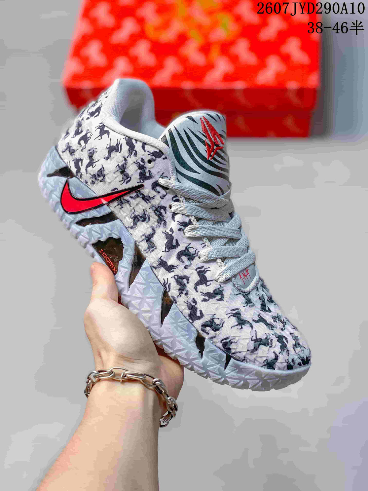 White Nike Ja 3 shoe with dark horse silhouettes, gray laces, red swoosh detailing, and a textured outsole.