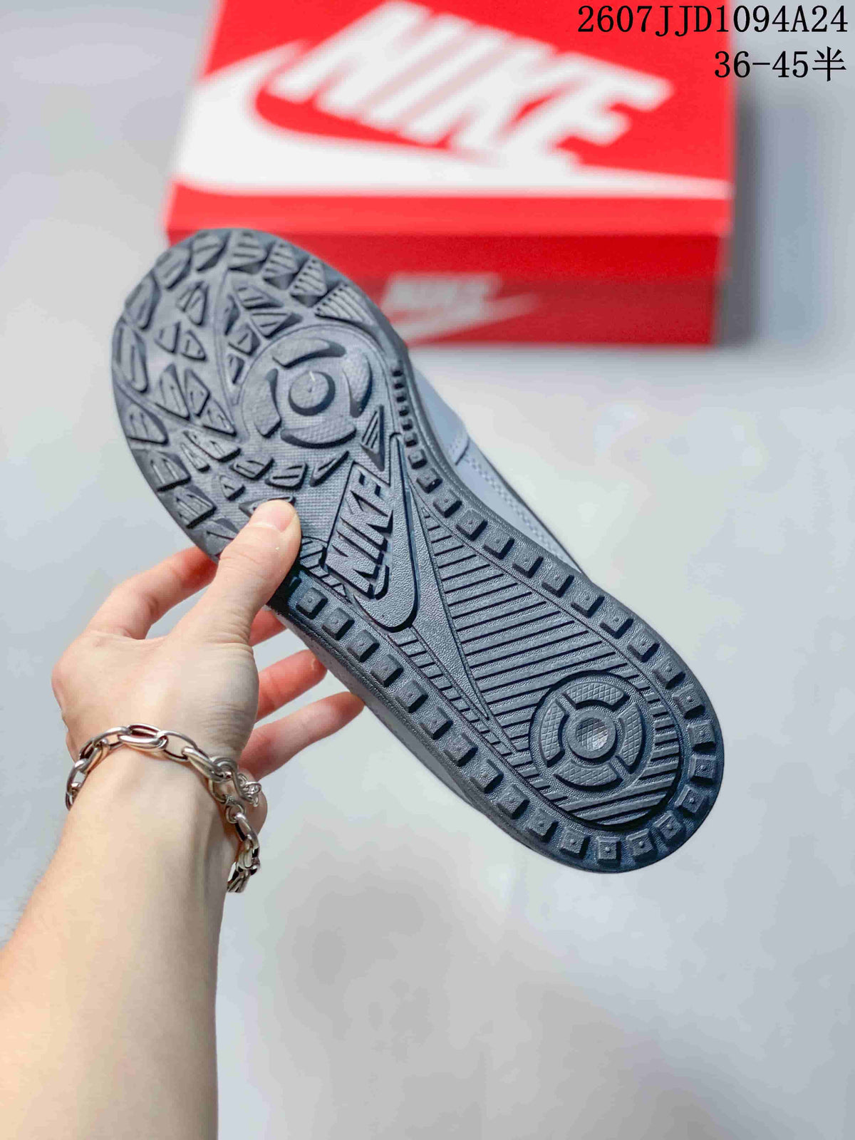 Close view of the gray sneaker outsole showing circular sections and raised geometric traction patterns.