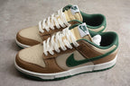 Angled pair view showing the low-top silhouette, cream and brown upper, green Swoosh, white laces, and green outsole.