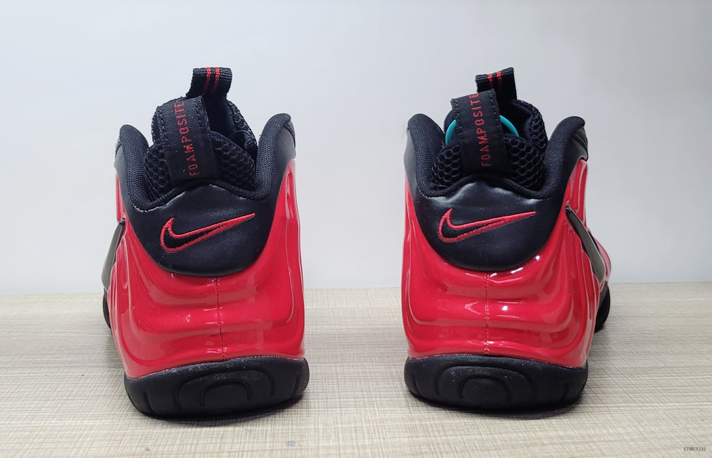 Rear view of red and black Nike Foamposite Pro sneakers