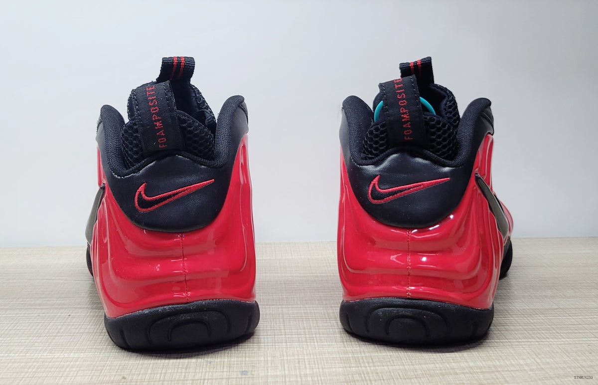 Rear view of red and black Nike Foamposite Pro sneakers