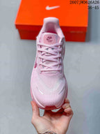 Top view of the pink lace-up sneaker showing the textured toe box, padded tongue, and branding details.
