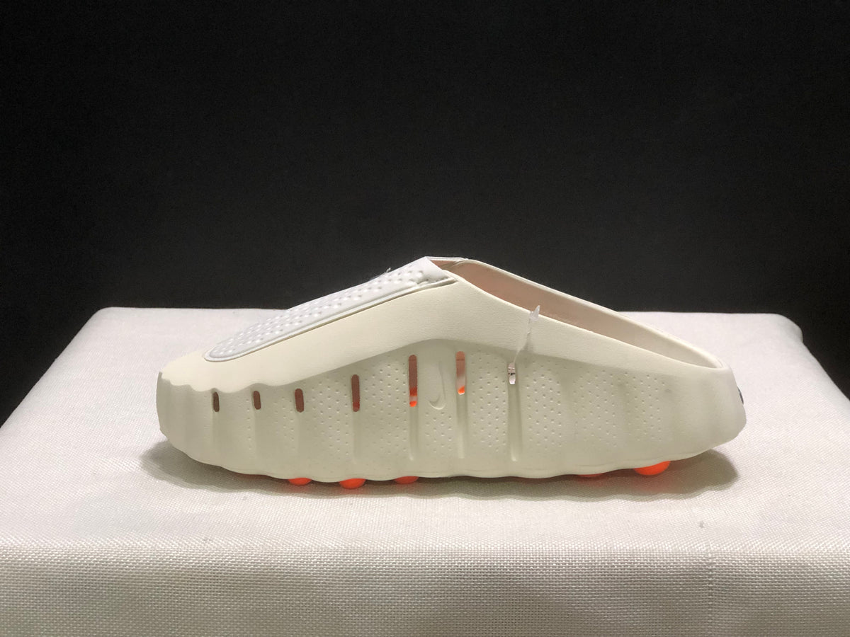 Lateral view highlighting the perforated sidewall, open-back construction, and orange outsole pods.
