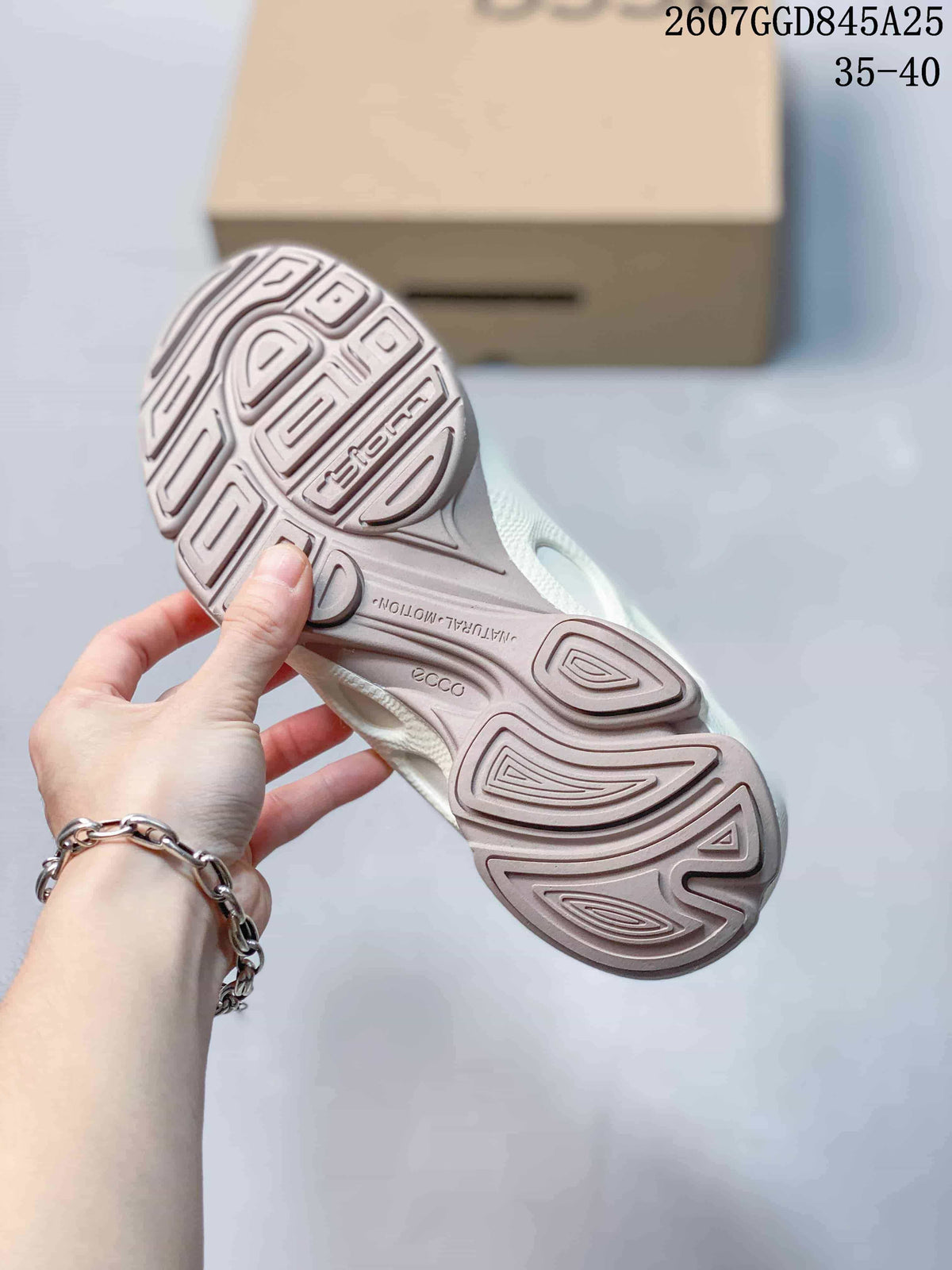 Underside view showing the sneakers' textured outsole with ECCO and Biom markings.