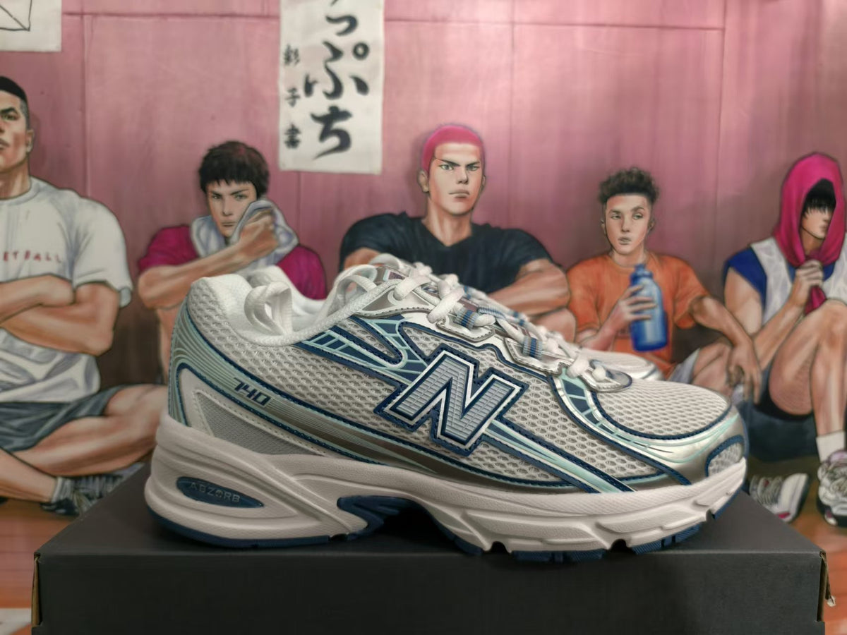 Side view showing the 740 marking on white and blue New Balance sneakers