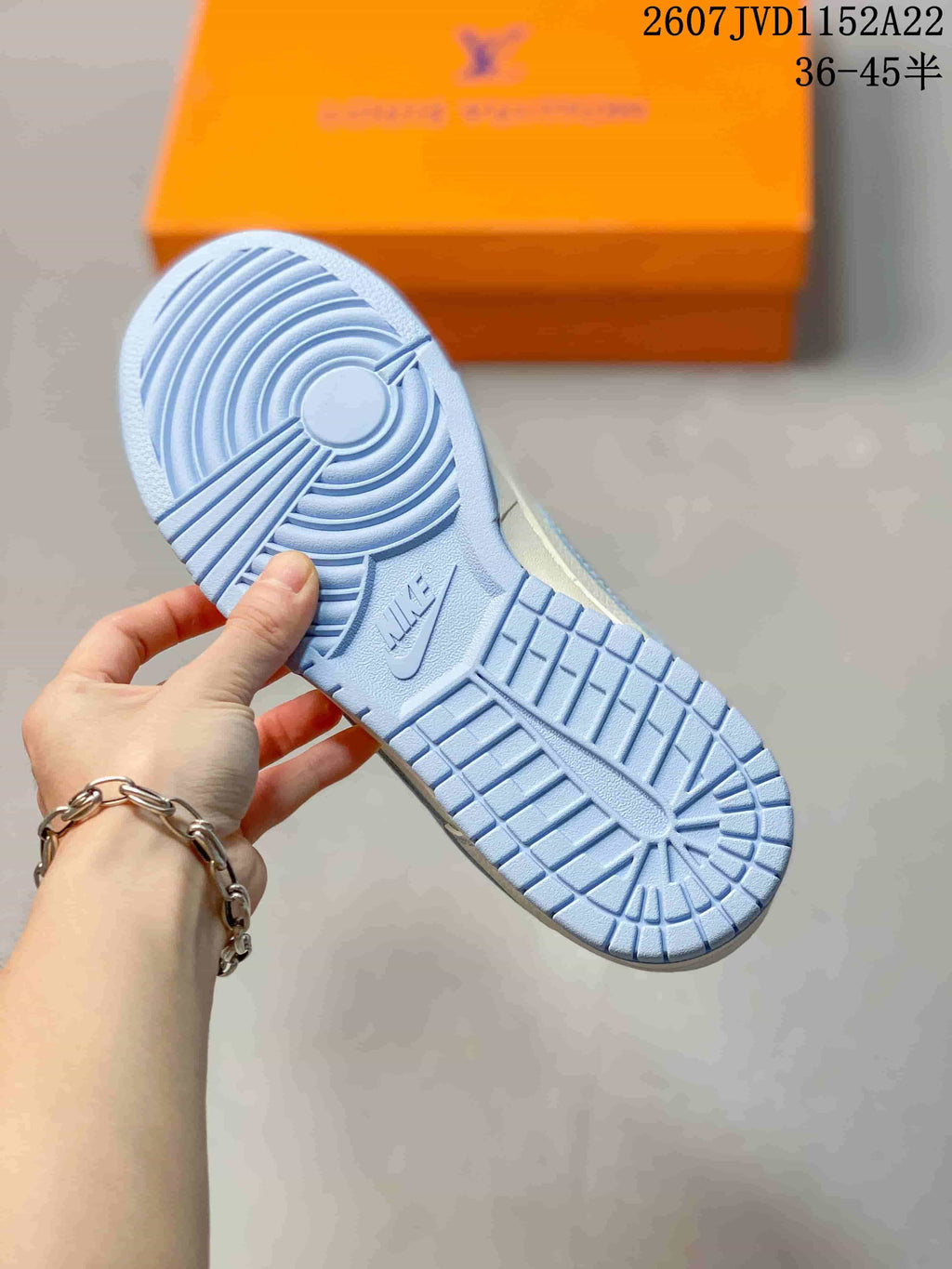 Close view of the light blue rubber outsole with circular and grid traction patterns.