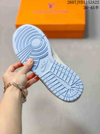 Close view of the light blue rubber outsole with circular and grid traction patterns.