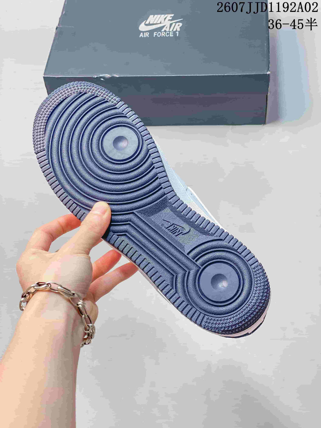 Underside of a sneaker showing a navy circular-pattern outsole