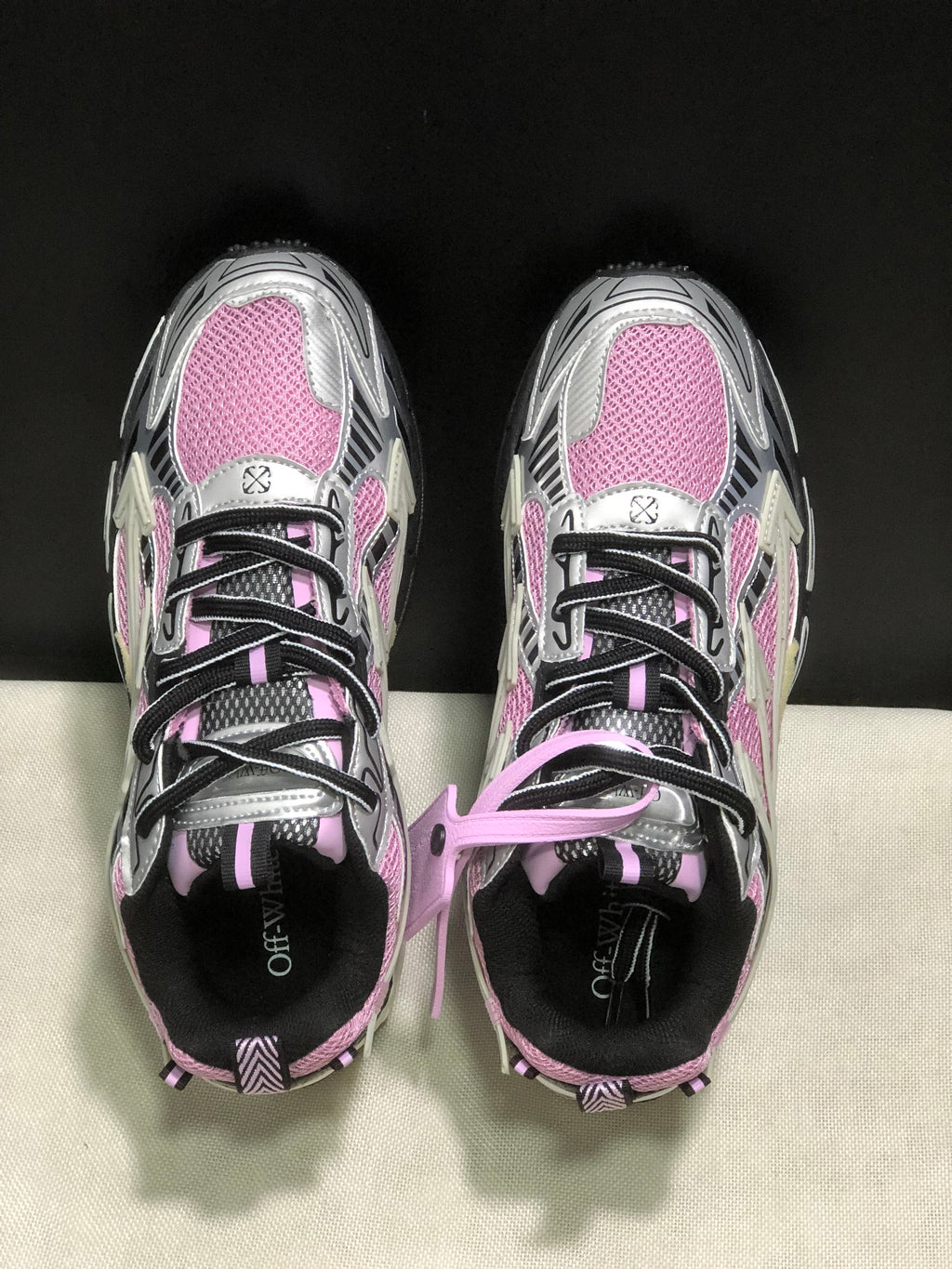 Top view showing the round toes, black laces, pink mesh panels, and tongue detailing.