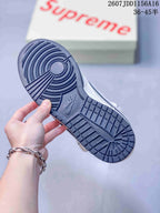 Close-up of the dark blue rubber outsole showing circular traction near the forefoot and patterned tread.
