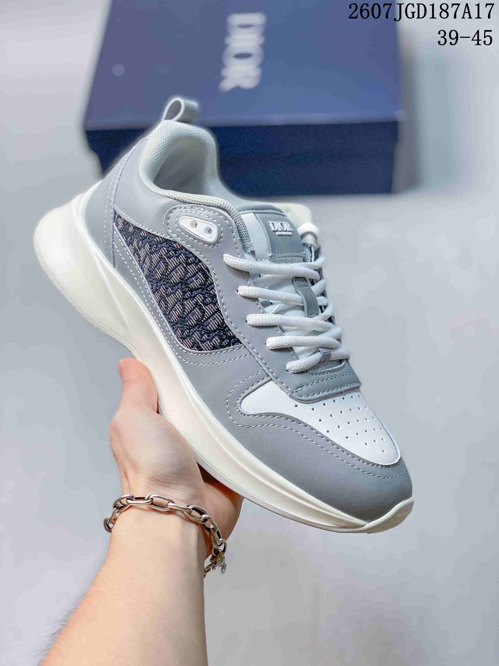 Light gray Dior B25 Runner sneaker with a dark patterned side panel and white outsole.