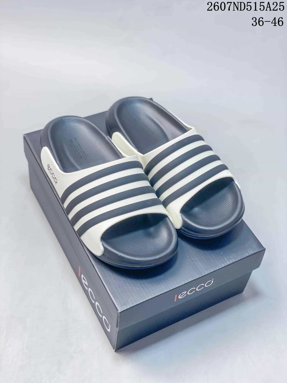 Pair of navy slide sandals with white striped uppers displayed on an ECCO box; style code 2607ND515A25 and size range 36–46 are visible.
