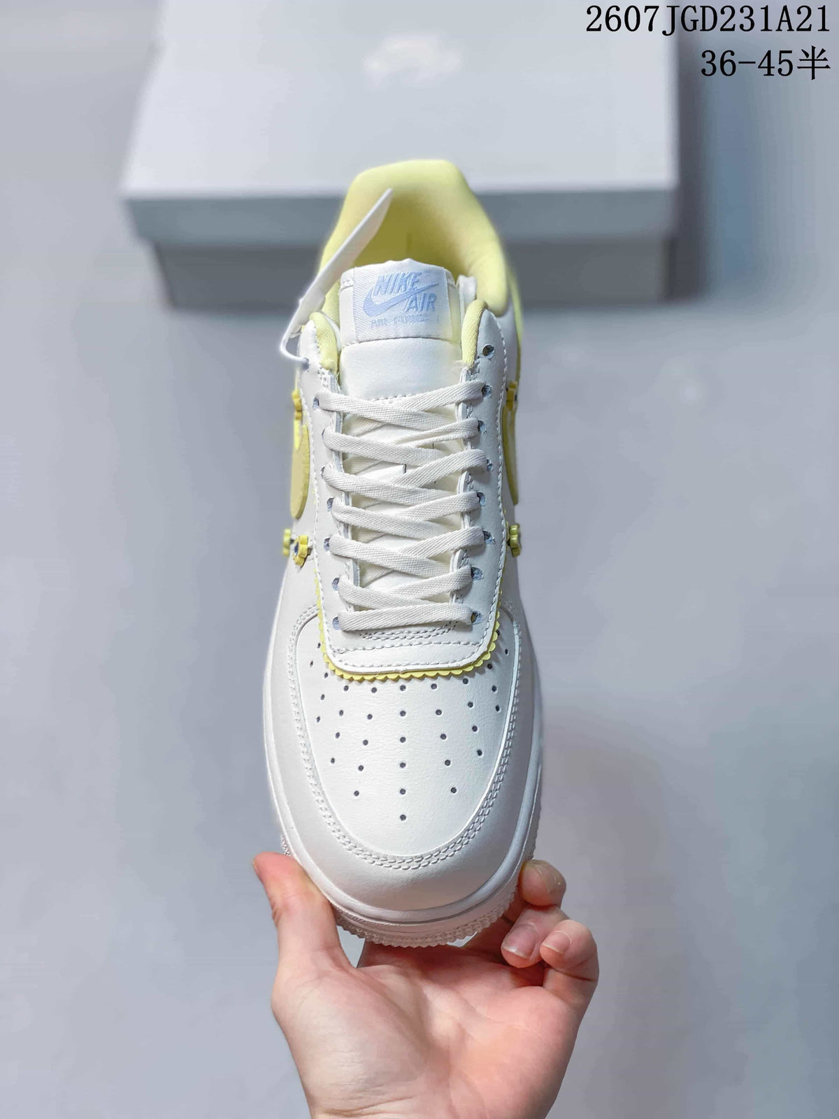 Top view showing white laces, a perforated toe box, pale yellow collar lining and branded tongue.