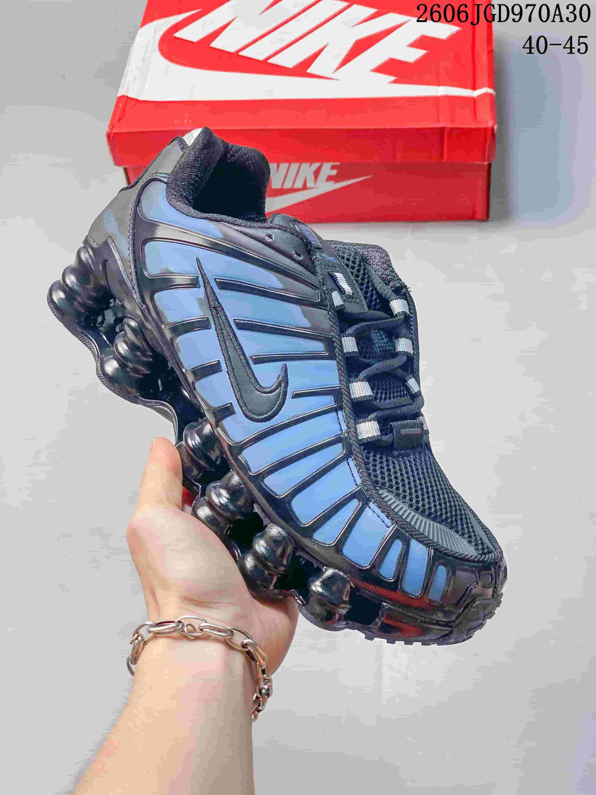Dark Nike Shox TL sneaker with blue side panels