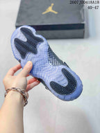 Underside view of a sneaker showing a translucent icy outsole with black patterned traction sections; the source-marked range 40–47 is visible.