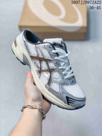 Angled close view of the white and silver ASICS Gel-1130 sneaker, showing the layered side panels, mesh upper, laces, and dark outsole; image text shows style code JJD972A22 and size range 36–45.