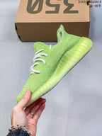 Side profile showing the light green knit upper and ribbed translucent sole.
