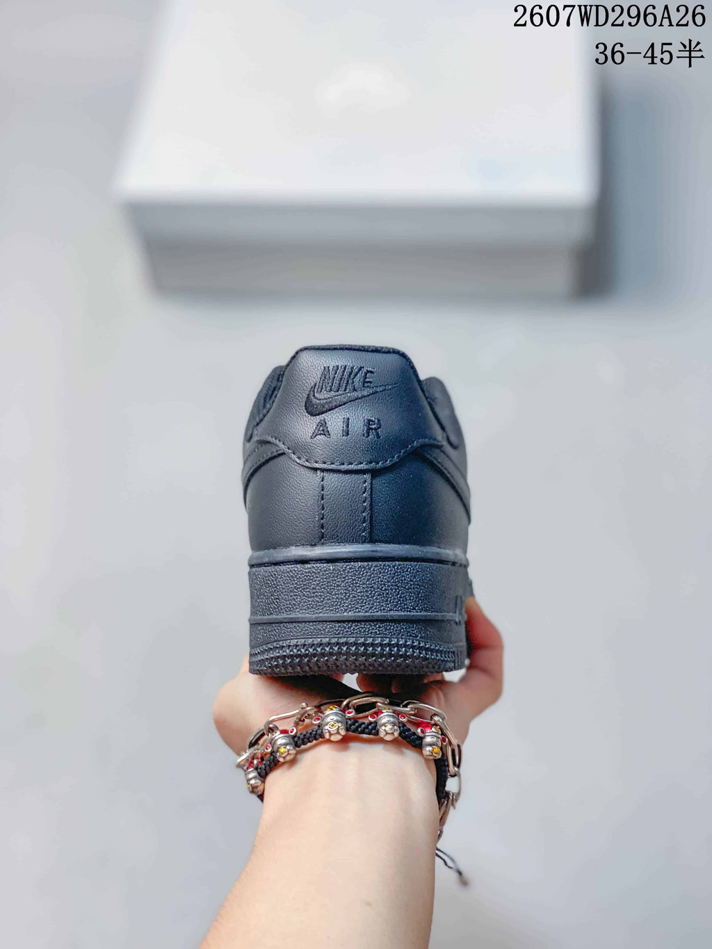 Rear view of a black sneaker showing Nike Air branding on the heel tab and a layered rubber sole.