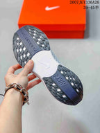 Underside view of the sneaker showing the textured black and gray rubber outsole and white midsole sections.