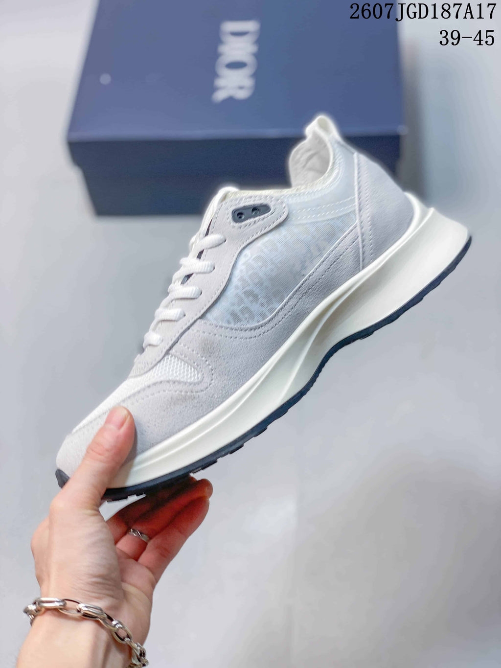 Side view showing the layered upper panels, translucent patterned side section, raised midsole, and dark outsole.