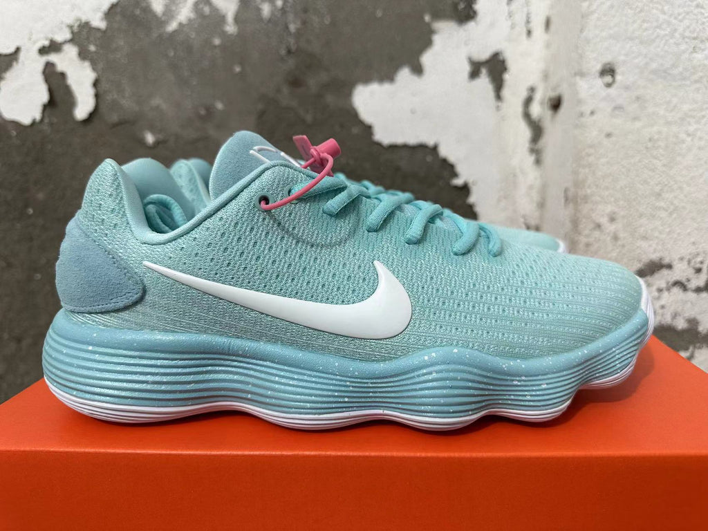 Side view of a mint green Nike sneaker with a white Swoosh logo and ridged sole