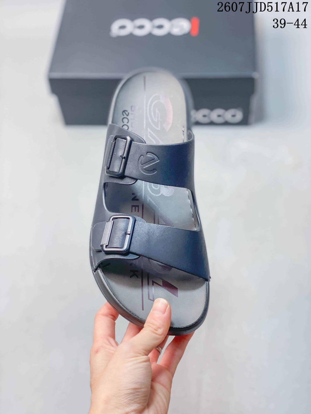 Top view of the dark gray sandal showing two adjustable buckles, broad straps, and the branded footbed.