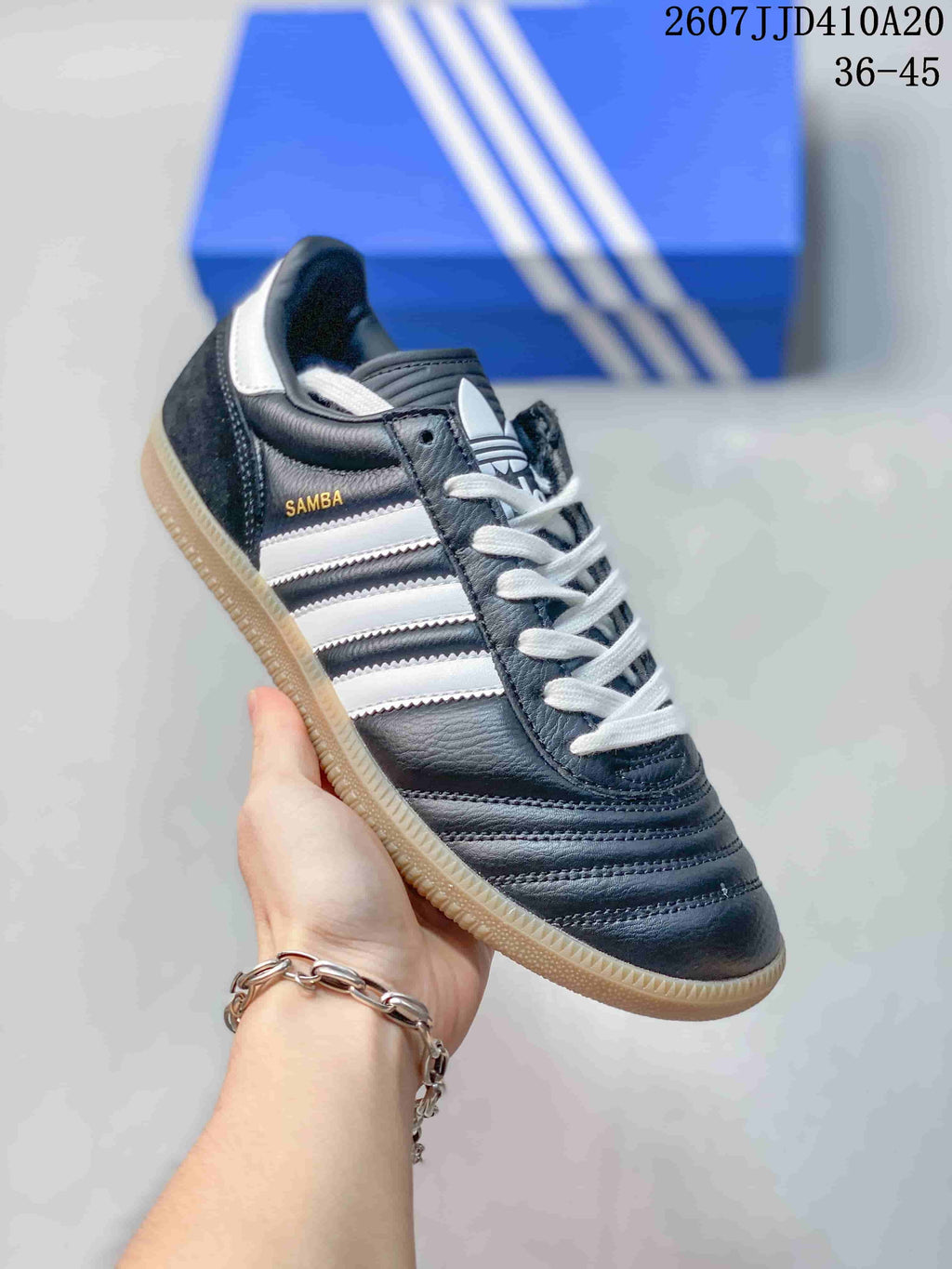 Angled side view showing Samba branding, white stripes, white laces, and gum outsole.
