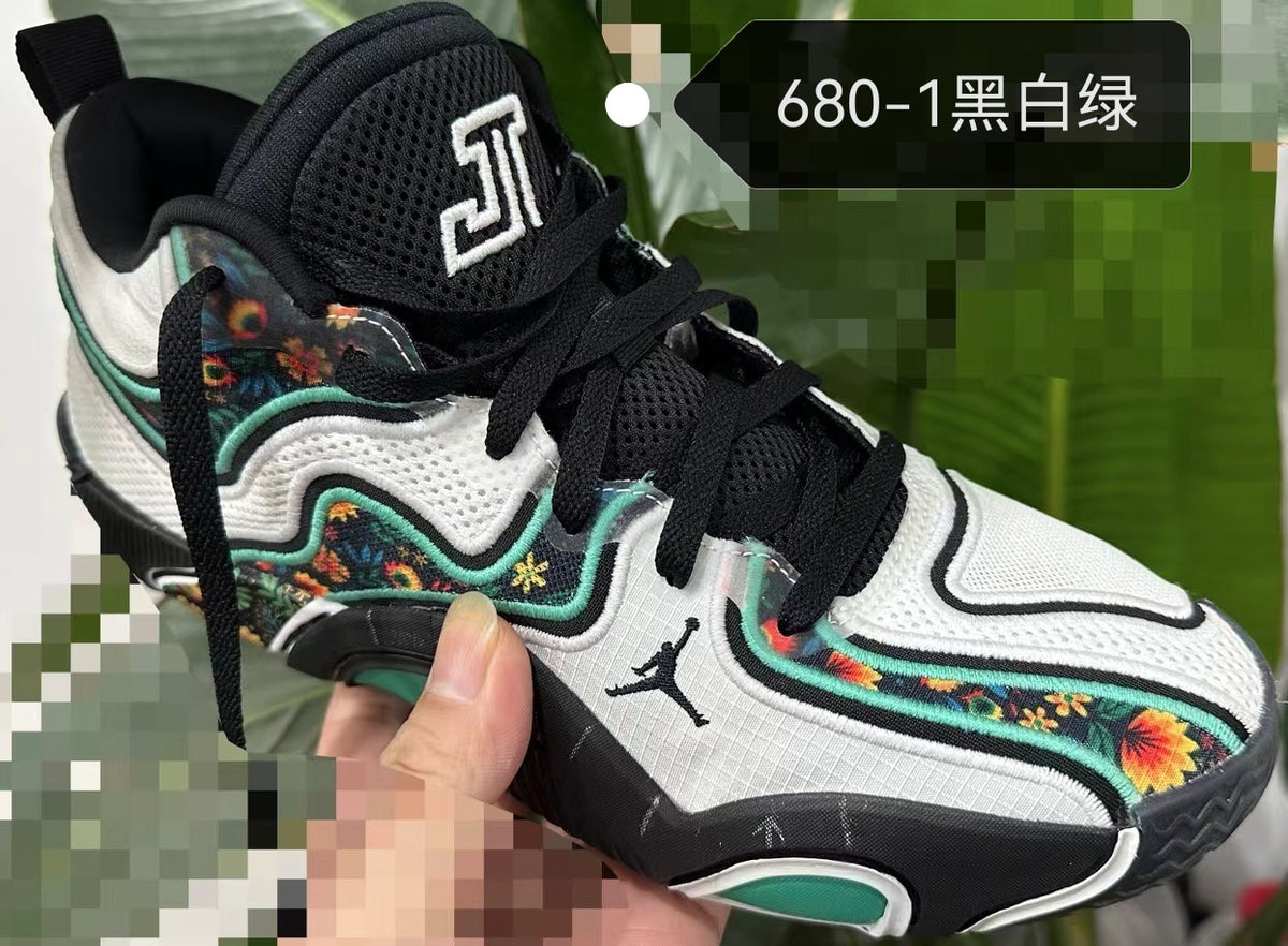 Jordan basketball shoe in black, white, and green with colorful patterned side panels
