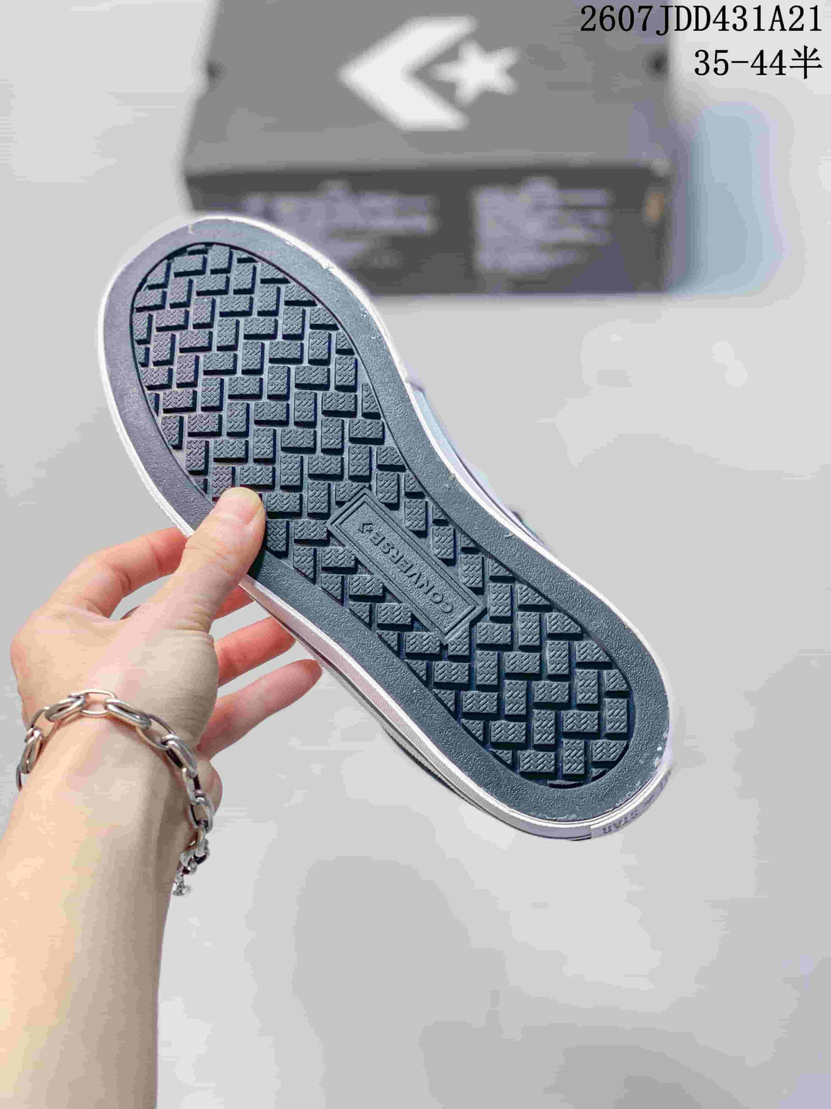 Underside of the sneaker showing a textured geometric rubber tread and Converse branding.