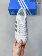 Top view of the lace-up sneaker showing its quilted toe and silver side stripes.