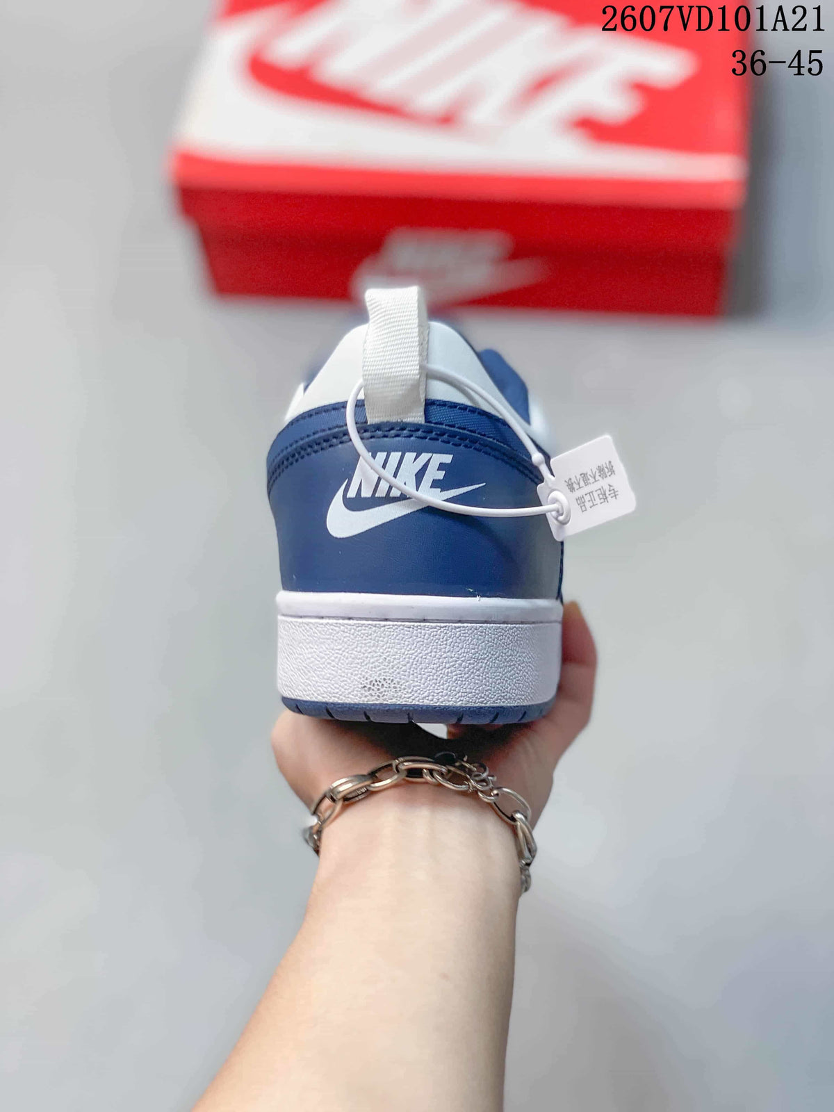 Rear view of the blue and white sneaker showing the heel branding, white midsole and pull tab.