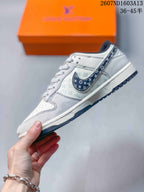 Side profile showing patterned Swoosh panels, pale printed side panels, and a low-top shape.
