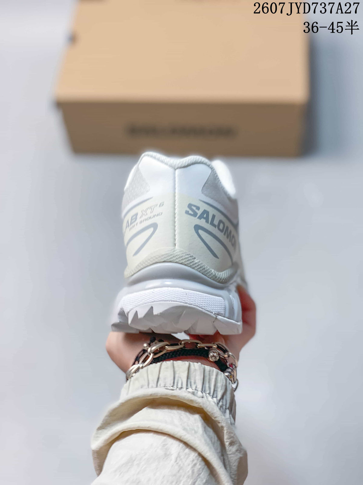Rear view of the sneaker showing the padded heel collar, Salomon branding, and textured outsole edge.