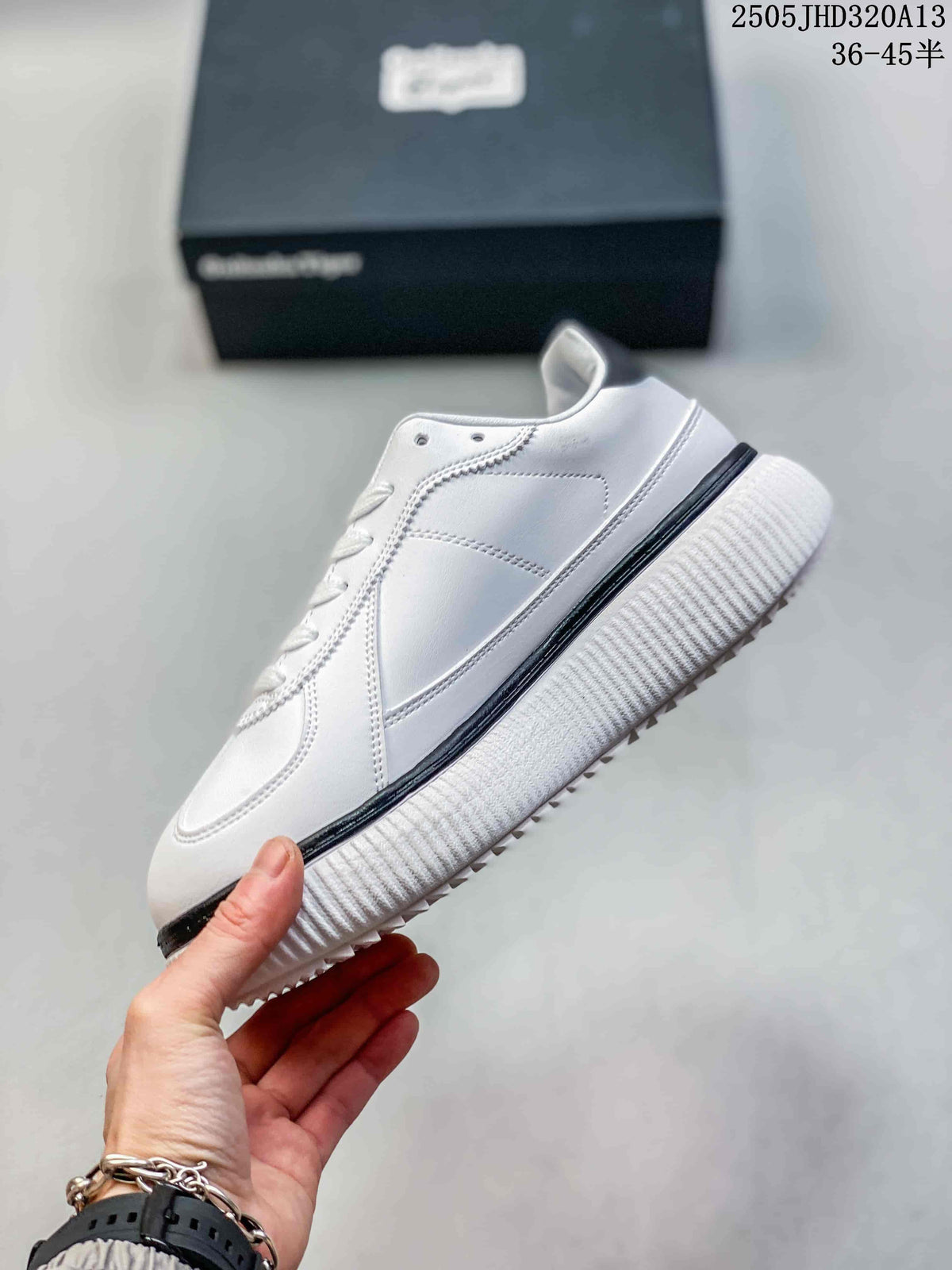 Side view of the white low-top sneaker with a black stripe and thick ridged sole