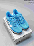 Blue Nike ACG Pegasus Trail sneakers displayed on an ACG shoebox, showing the lace-up upper, white Swoosh, and white midsole.