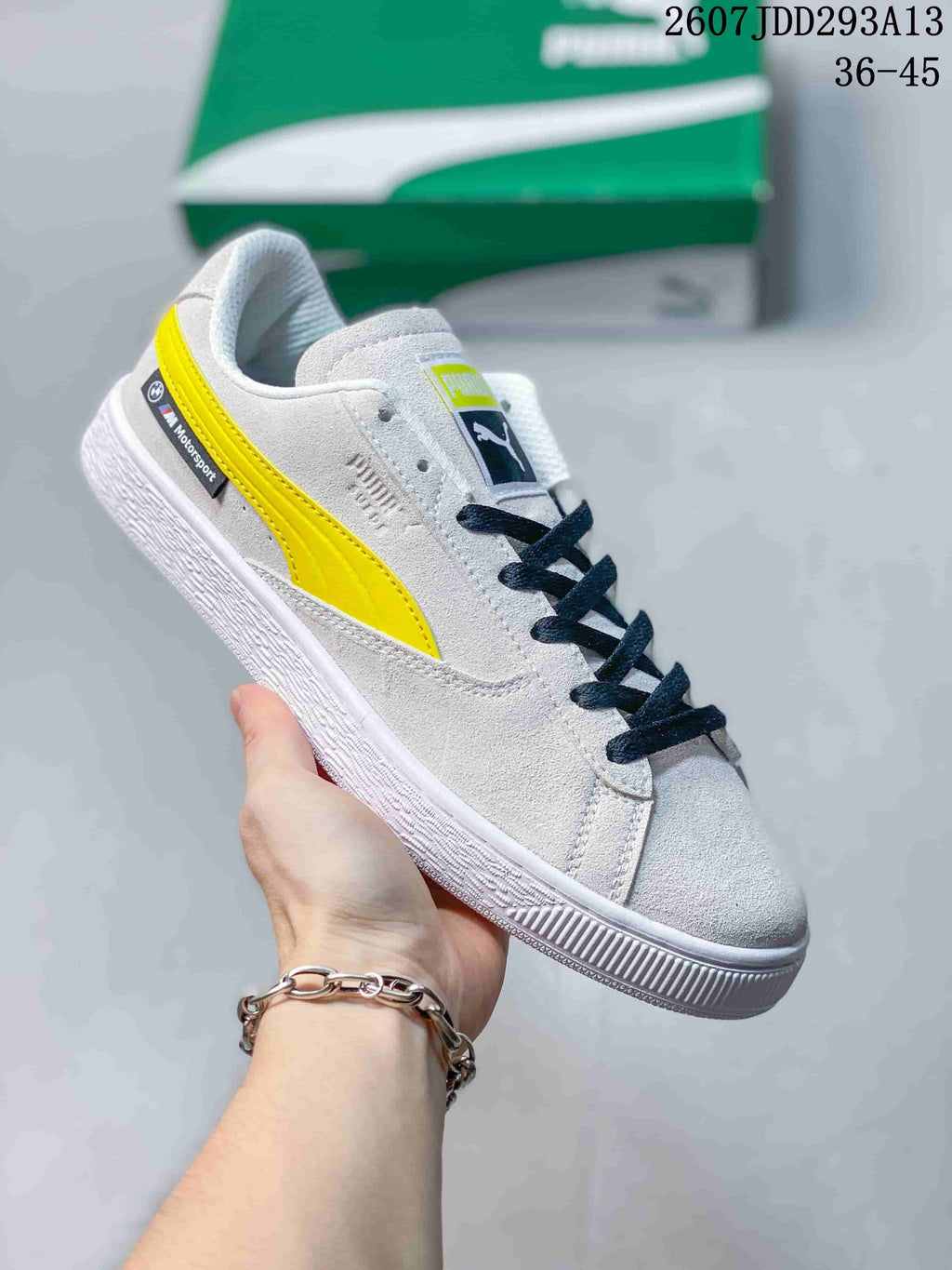 Light gray PUMA BMW M Motorsport sneaker with a bright yellow side stripe, dark laces and a white outsole.