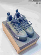 Pair of green-gray The North Face GLENCLYFFE low-top hiking shoes on a shoebox.