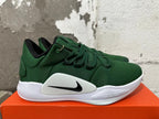 Side view of a green Nike shoe showing the black swoosh and Zoom lettering