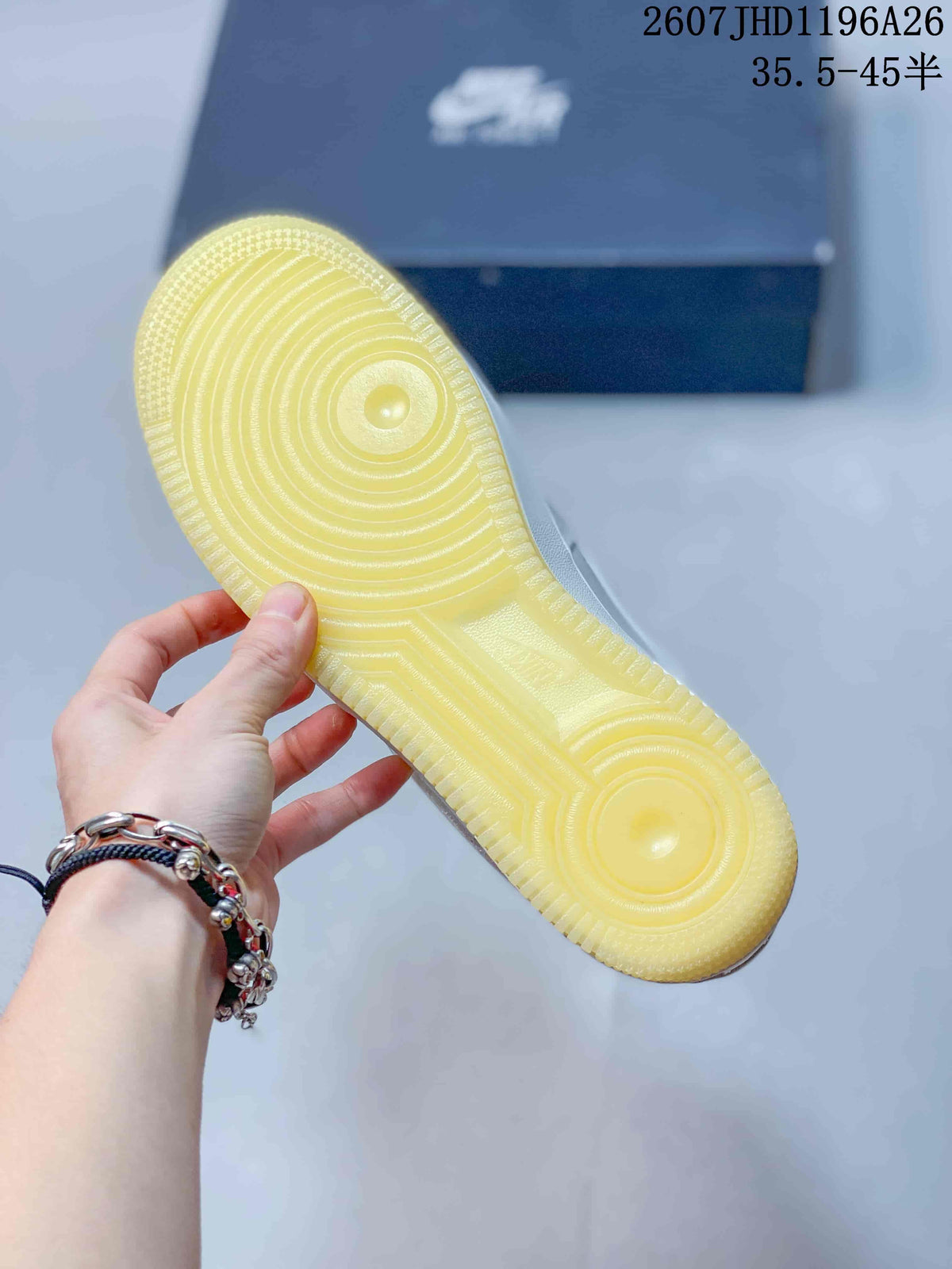 Close-up of the translucent yellow rubber outsole with concentric traction patterns.