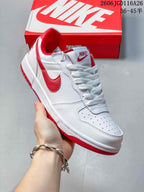 Angled side view of the white and red Nike low-top sneaker