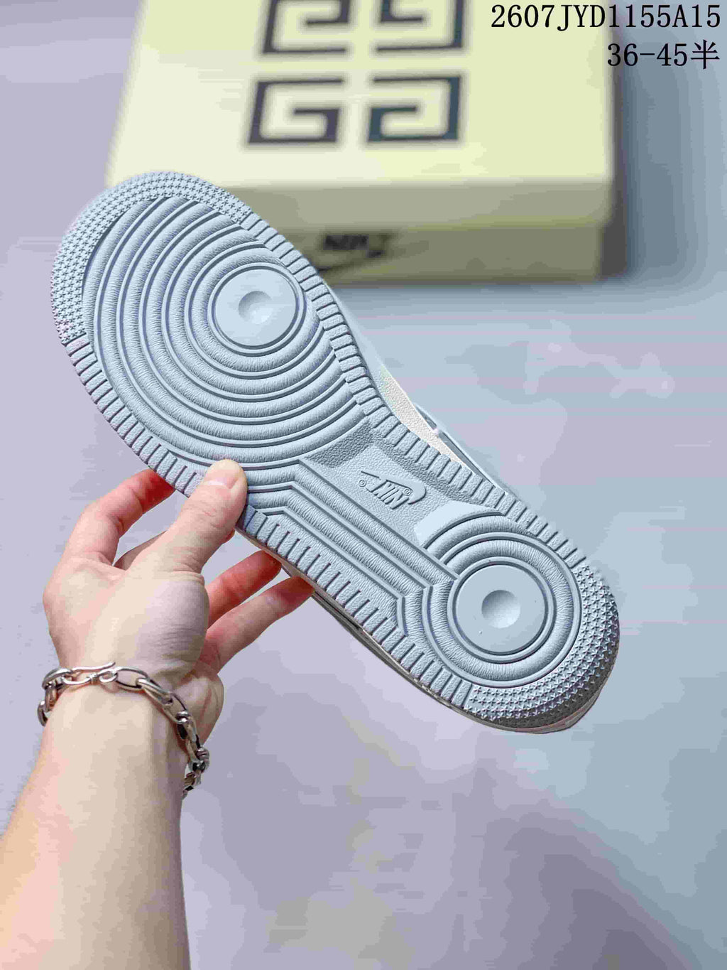 Close view of the sneaker outsole showing the gray rubber tread with concentric circular grooves and textured traction edges.