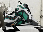 Pair of black, white, and green Jordan basketball shoes, one displayed across the other.