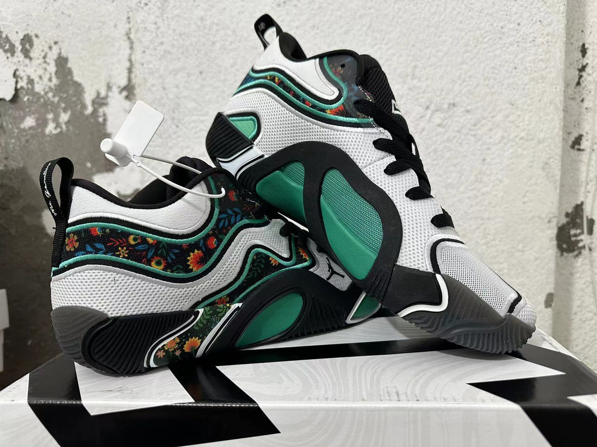 Pair of black, white, and green Jordan basketball shoes, one displayed across the other.