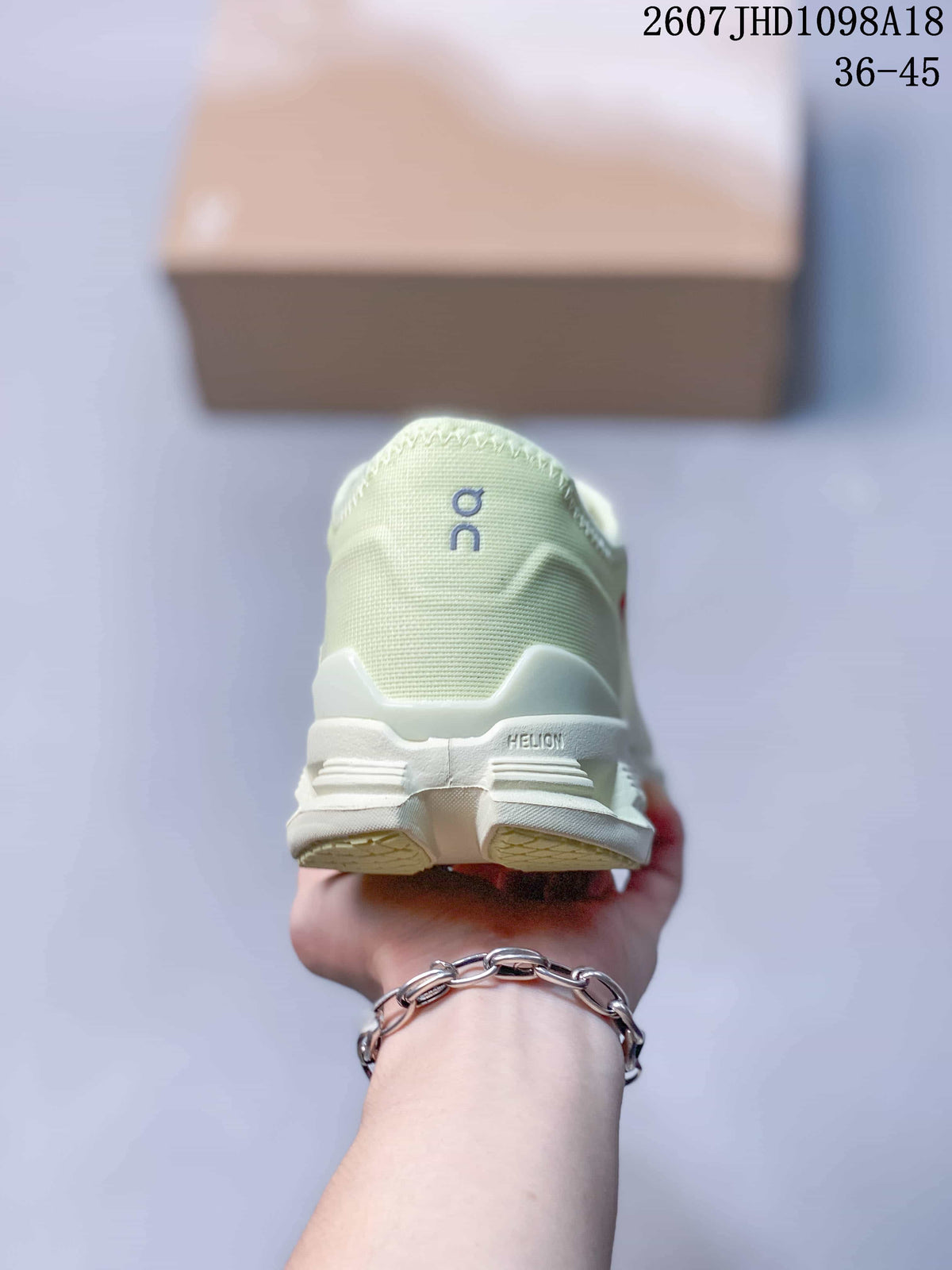 Rear view of the pale green sneaker showing the heel construction and On branding.