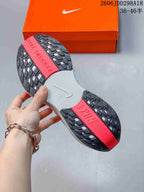 Close view of the sneaker outsole showing black tread sections, red traction panels, and a white center section.