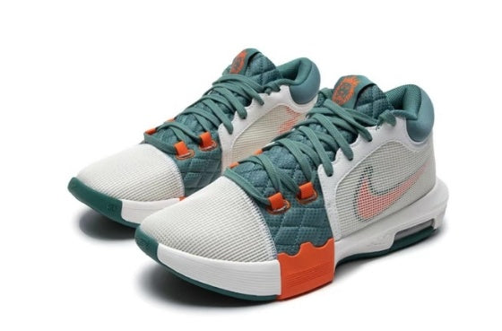 Pair of low-top basketball shoes in white, teal, and orange.